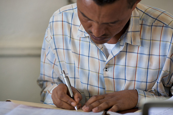 Social worker Gashaw Dinku enters beneficiary data.